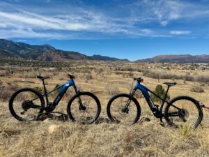 two bikes in a park with mountains in the background