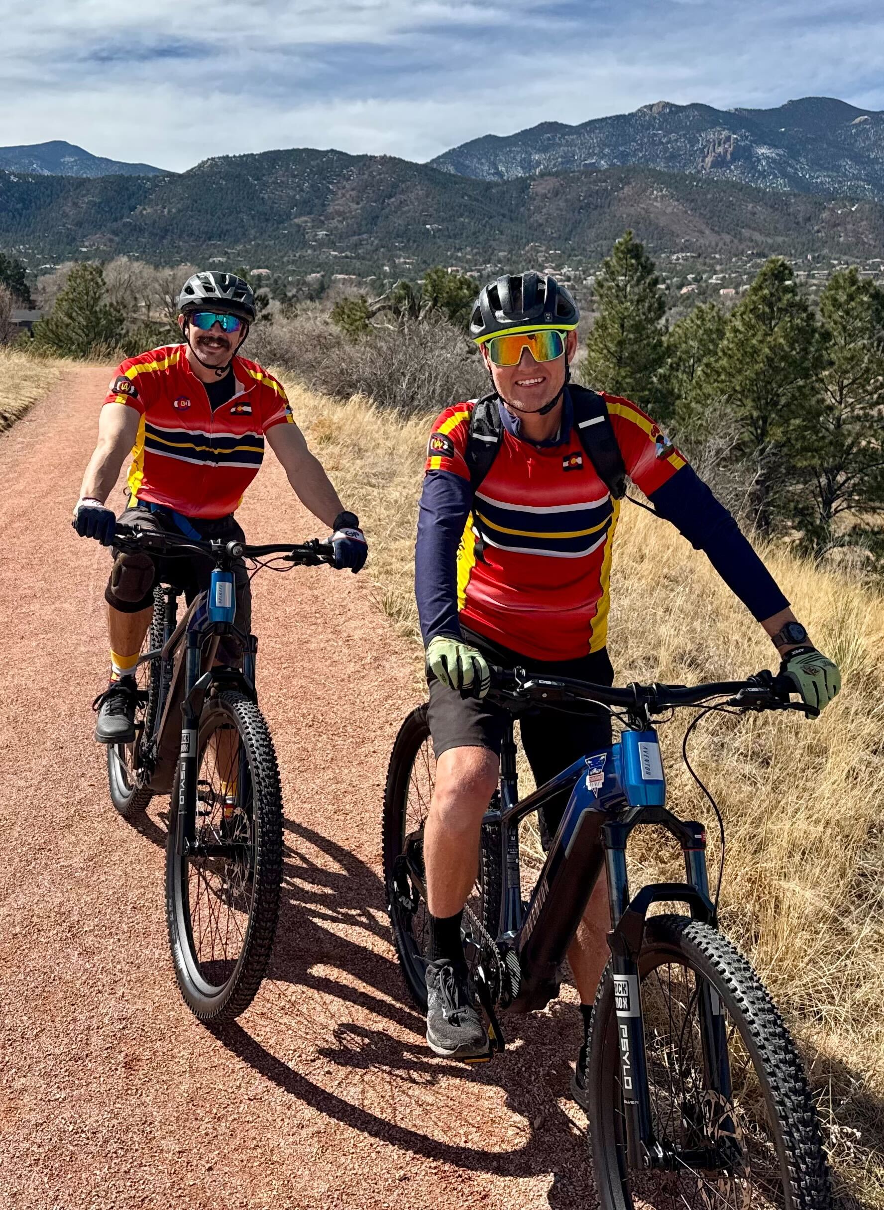 two bike riders on dirt trail